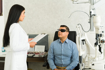 Eye health discussion between doctor and patient wearing an eye patch for his recovery