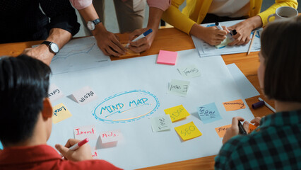 Top view of business team in casual cloth hand writing idea on sticky notes. Closeup of diverse...