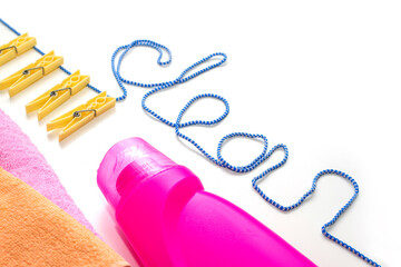 Towels, detergent, clothespins, clothesline for drying clothes on a white table. Washing, cleaning, cleanliness