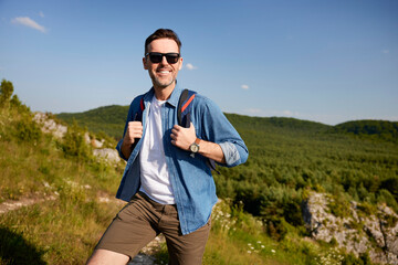 Happy man hiking with backpack