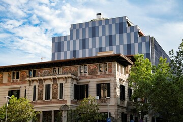 old residential building in front of modern office building in 