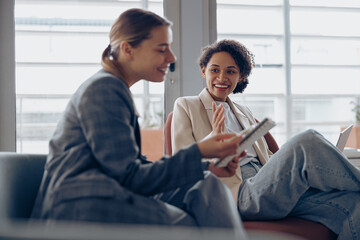 Woman office worker discussing new project with colleague during working day in coworking