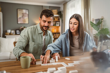 boyfriend and girlfriend play dominoes at home have fun together
