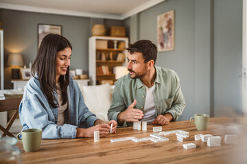 boyfriend and girlfriend play dominoes at home have fun together