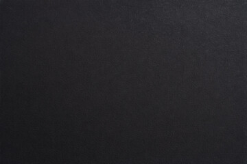 Dark, finely textured rubber, fabric or synthetic surface