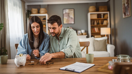 Happy boyfriend and girlfriend save money together in the piggy bank