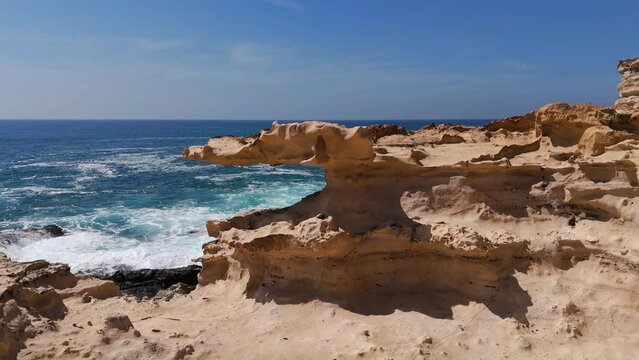 Aerial clip of a rock formation like a crocodile due to incredible wind and water erosion of the sandstone rock in Fuerteventura Canary Islands Spain