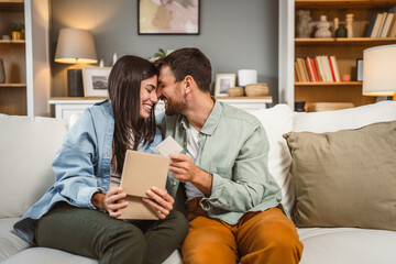Girlfriend open her birthday present from her boyfriend at home