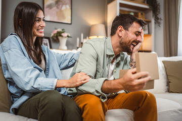 Boyfriend open his birthday present from his girlfriend at home