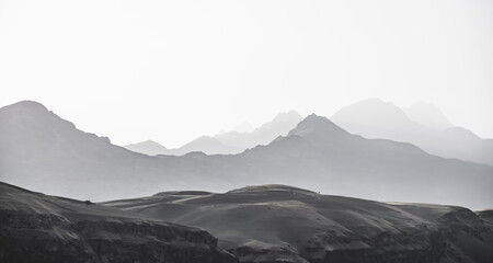 Panorama of a mountain range in the morning at dawn, tonal perspective of mountains in the morning haze in the Pamirs in Tajikistan
