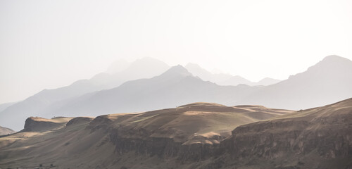 Panorama of a mountain range in the morning at dawn, tonal perspective of mountains in the morning...