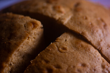 Close shot of Freshly baked cakes slices on a plate on a stool in a bakery