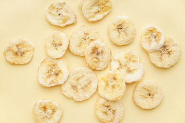 Tasty freeze-dried banana on beige background