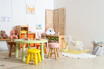 Interior of light playroom with toys in kindergarten