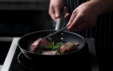 Chef frying meat steak