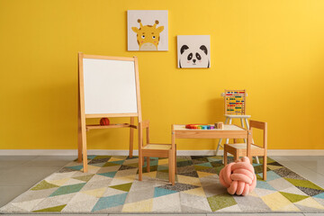 Interior of playroom with toys and whiteboard in kindergarten