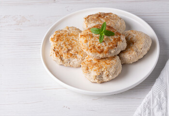 Roasted chicken cutlets on white plate