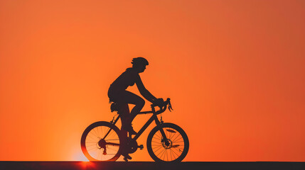 Fototapeta premium Mountain bike through a vast desert landscape at sunrise. Silhouette against the orange sky.