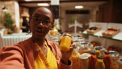 POV of african american buyer filming products at farmers market, promoting sustainable lifestyle and healthy nutrition with locally grown food. Woman recommending zero waste store. Handheld shot.