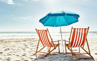 Rest, relax and beach chairs with umbrella on sand for vacation, holiday or weekend break. Summer,...