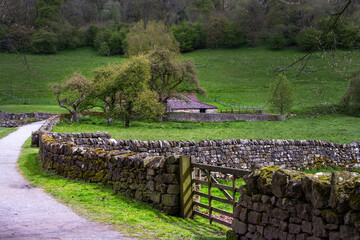 View in the North York Moors National Park in spring. Barn and dry stone wall.