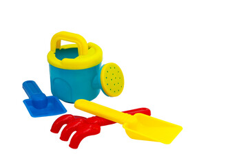 Children's toys for playing in the sand. Children's shovel, watering can and sandpit rake isolated without background. For text