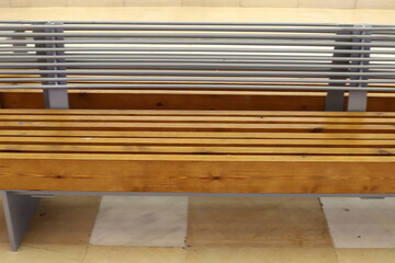 A bench for relaxing in a city park on the seashore.