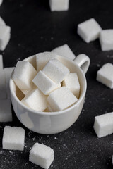 white square sugar on a black background