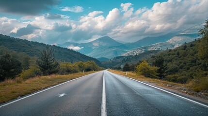 Fototapeta premium a long road with a mountain range in the background