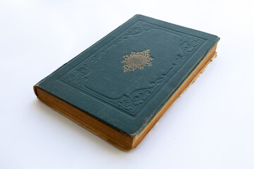 Fototapeta premium green coloured damaged cover of a very old book. yellowed natural paper texture. isolated on white background. clean close-up.