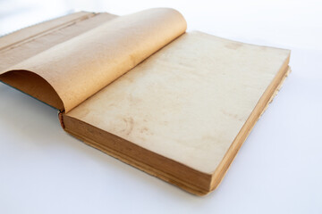 inner page of a very old book. yellowed natural paper texture. on isolated white background. clean close-up.