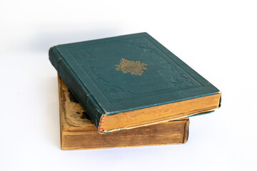 Old damaged books stacked on top of each other. Yellowed natural paper texture. On isolated white background. Clean close-up.