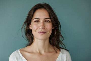 A close up portrait of a young woman with a subtle smile