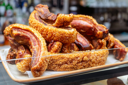 TORREZNOS TRAY FROM SORIA, SPAIN. TYPICAL SPANISH FOOD OF FRIED PORK BACON. SELECTED FOCUS.	