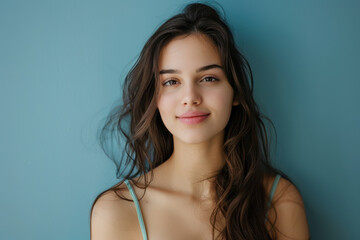 A close up portrait of a young woman with a subtle smile