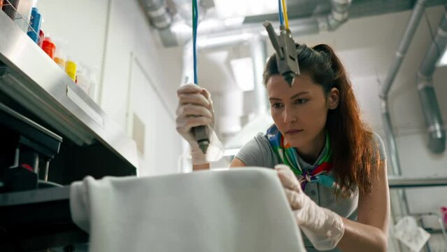 professional dry cleaning young girl bleaches a stain on a white jacket professional equipment