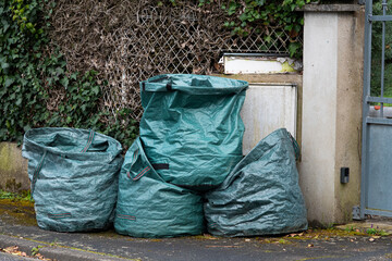 bags full of bulky waste in front of the garden entrance