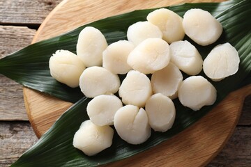 Fresh raw scallops on wooden table, top view