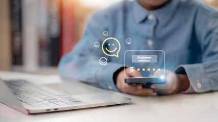 Customers press on the smartphone screen with a gold five-star rating feedback icon and press level excellent rank to give the best score point to review the service, business concept