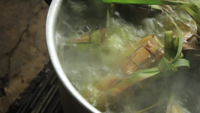 Boiling Ketupat in a pot