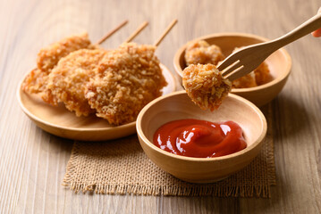 Deep fried chicken pops dipping with ketchup, Thai street food