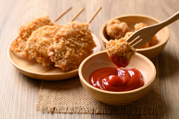 Deep fried chicken pops dipping with ketchup, Thai street food