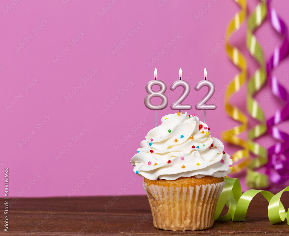 Wall mural birthday cupcake with candles lit forming the number 822