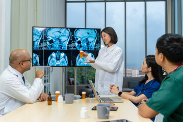 Group of professional doctors engaged in a discussion or meeting in a medical office. A large...
