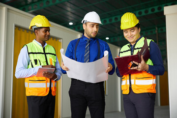 workers or engineers planning from work on blueprint drawing paper in the factory