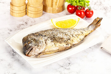 Baked Dorado fish served lemon