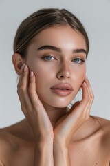 Fototapeta premium Spa or cosmetics advertisement, beauty concept, cosmetic concept, skin medical beauty concept, beautiful woman touching her face with beautiful skin, young girl model touching neck,