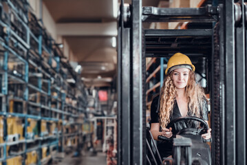 Engineer woman driving forklift at goods warehouse cargo and check for control loading from Cargo freight ship for import and export. Teamwork concept