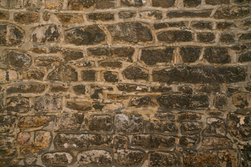 old brown stone wall texture and background, close up