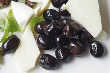 black olive and cheese on a plate 